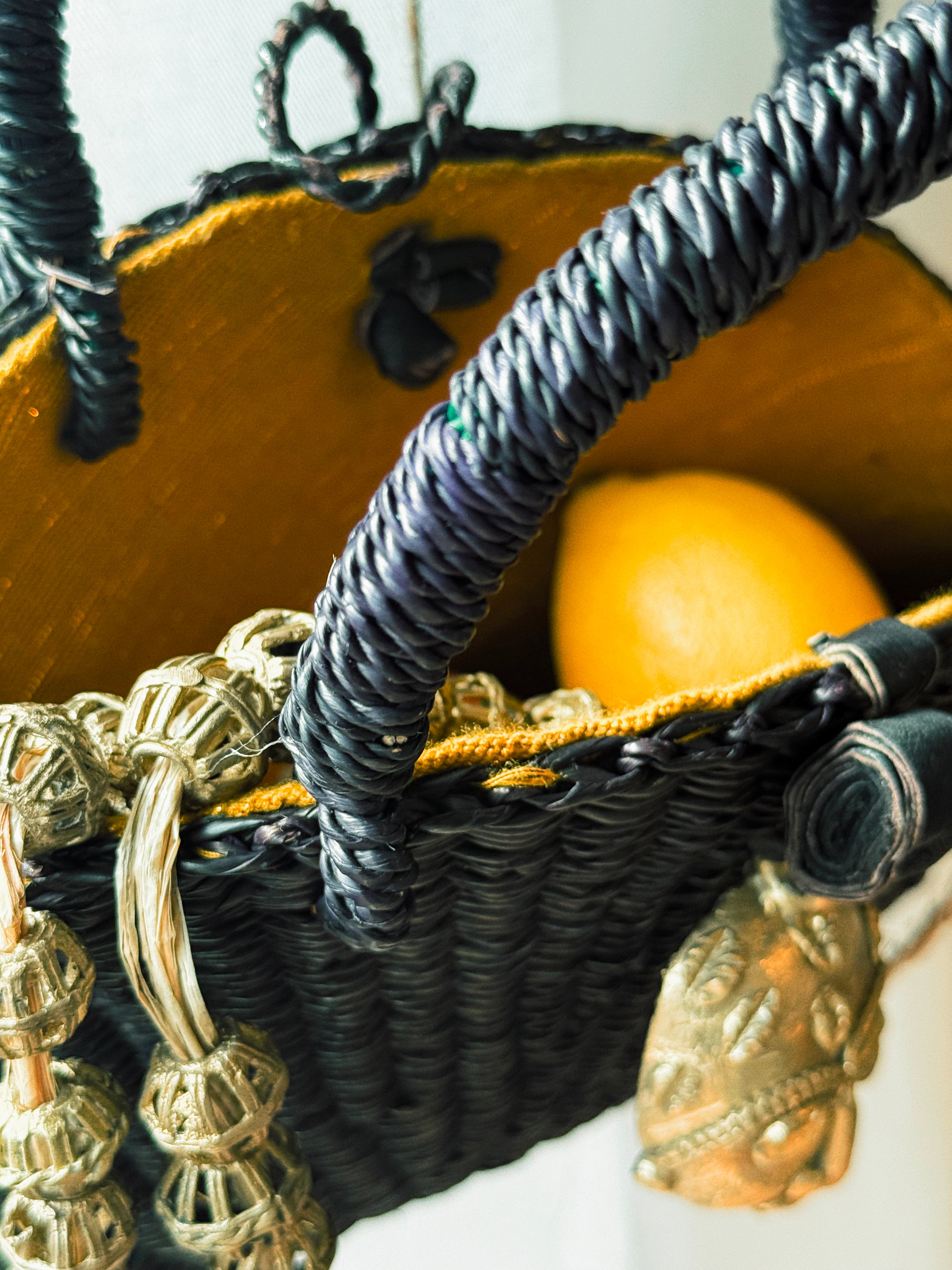 Handwoven Black Half-Moon Raffia Bag with Brass Mask – Artisan Made in Ghana