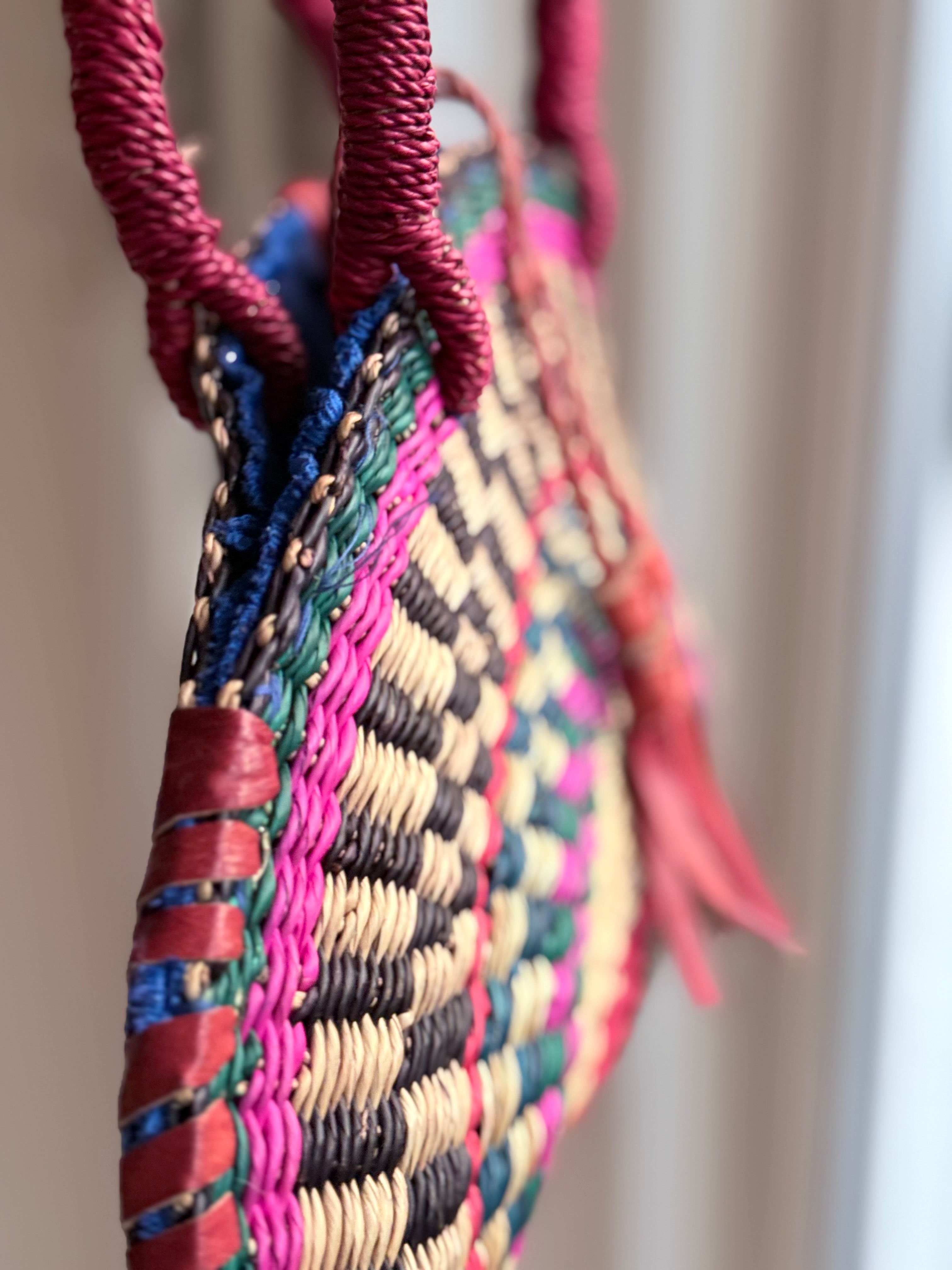 African Handwoven Half-Moon Bag with Brass Mask Pendant & Red Handles