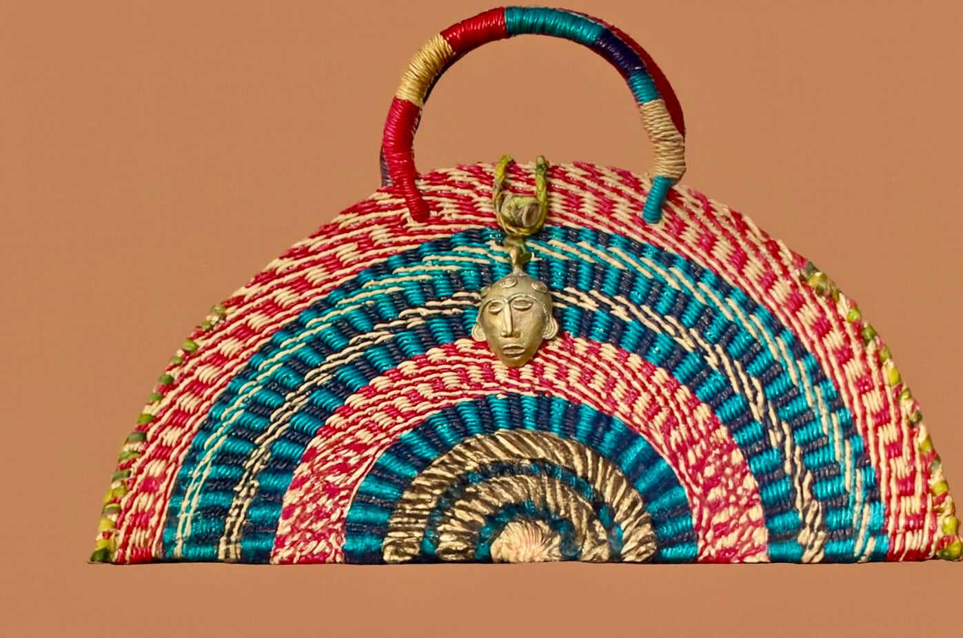 Handwoven Half-Moon Mini Bag with Brass Mask Pendant