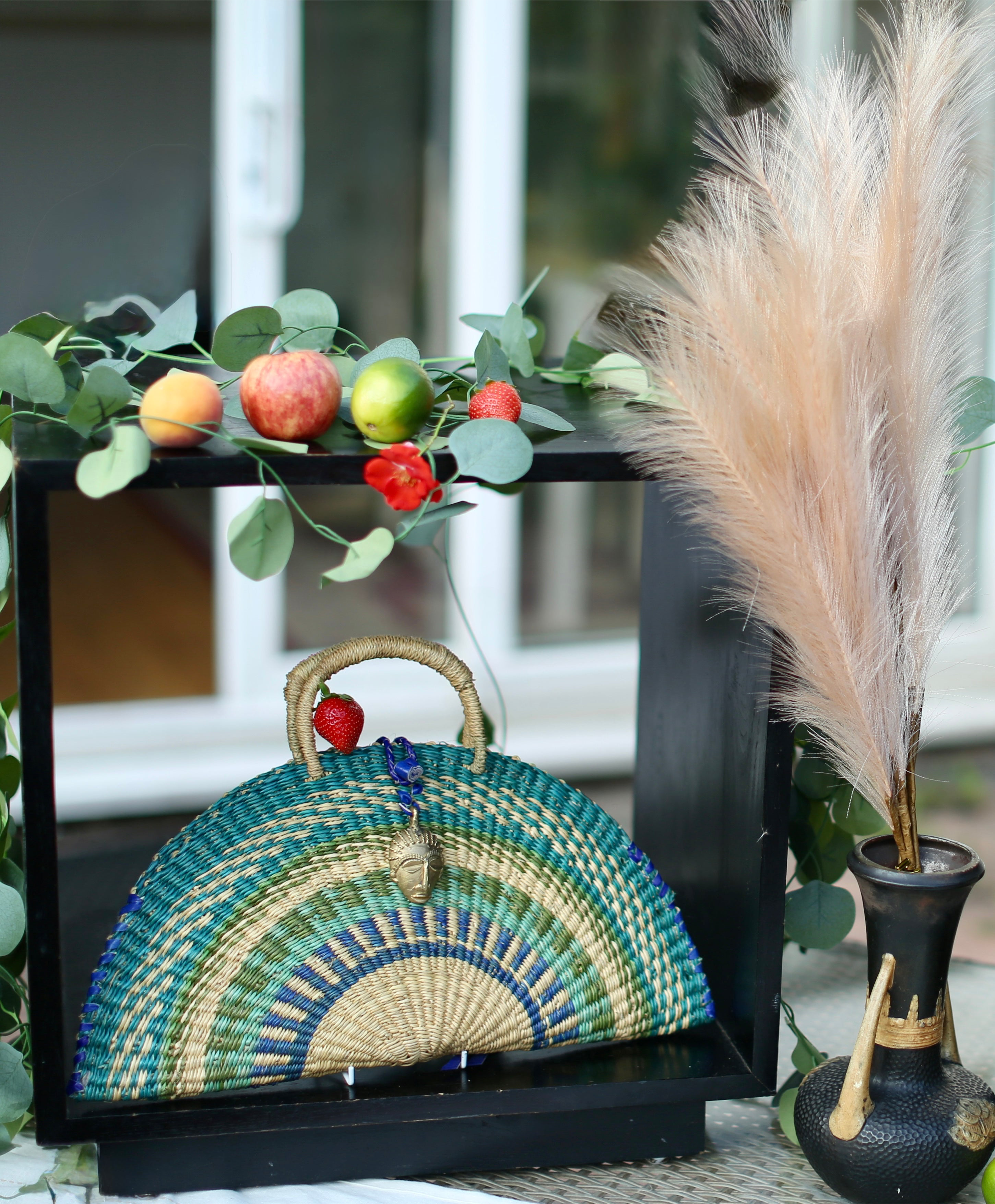 Handwoven Green & Natural Half-Moon Bag with Brass Mask Pendant